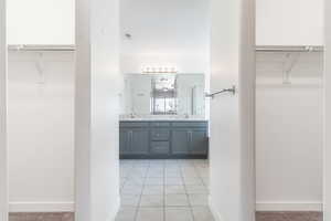 Bathroom featuring tile patterned flooring and vanity