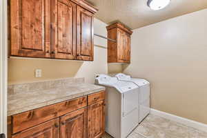 Laundry features ample cabinets, counter top space, and hanging bar. Washer/Dryer negotiable