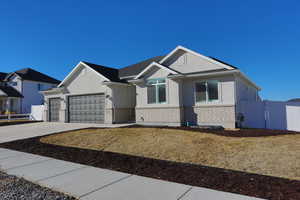 View of front facade with a front lawn and a garage