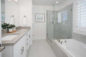 Bathroom with vanity and separate shower and tub