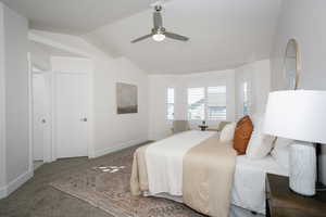 Bedroom with ceiling fan, carpet, and vaulted ceiling