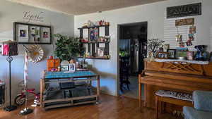 Misc room with wood-type flooring and a textured ceiling