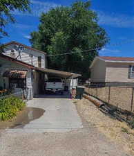 View of side of home with a carport