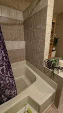 Primary bathroom featuring curtained shower