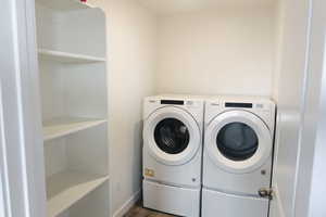 Washroom featuring independent washer and dryer and dark hardwood / wood-style flooring