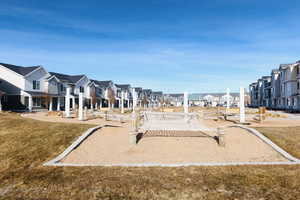 View of property's community with a lawn and play area.