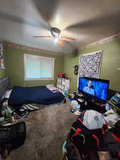 Carpeted bedroom with ceiling fan