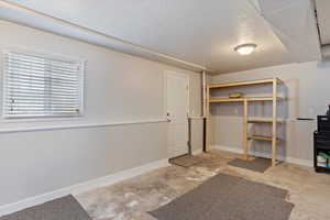 Unfurnished bedroom featuring a closet and a textured ceiling