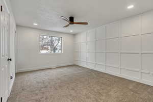 Unfurnished room with carpet and ceiling fan