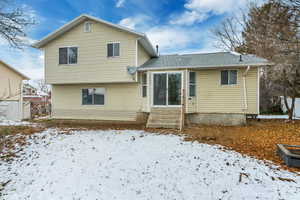 View of snow covered rear of property