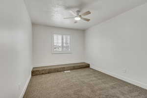 Spare room with carpet flooring and ceiling fan