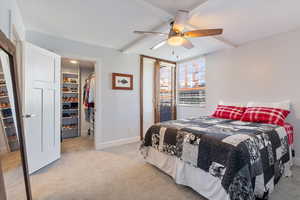 Bedroom with ceiling fan, beam ceiling, and light colored carpet