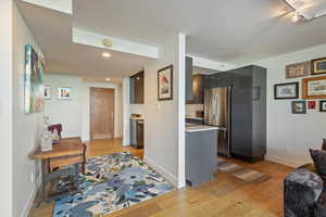 Kitchen featuring backsplash, stainless steel appliances, and light hardwood / wood-style flooring