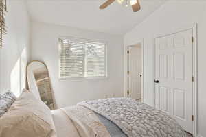 Bedroom with ceiling fan and lofted ceiling