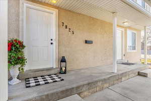 Doorway to property featuring a porch