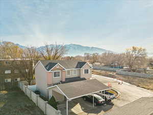 View of front of property with a mountain view and a carport