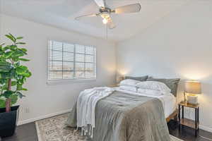 Bedroom featuring dark hardwood / wood-style floors and ceiling fan