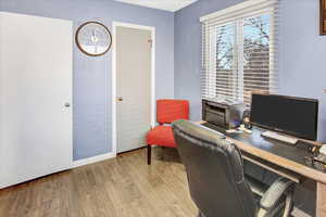 Office with light hardwood / wood-style floors