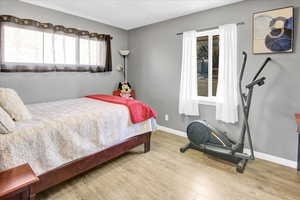 Bedroom featuring hardwood / wood-style floors and a textured ceiling