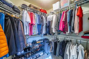 Spacious closet featuring carpet flooring