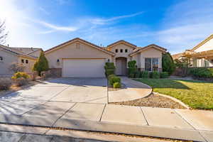 View of front of property with a 2.5 garage and a front yard