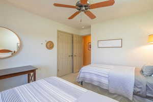 Carpeted 2nd bedroom with ceiling fan