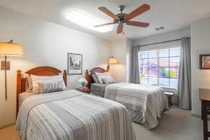 2nd bedroom featuring light carpet, box window, and ceiling fan