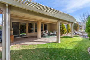 Back of house featuring an outdoor hangout area, a patio area, and a lawn