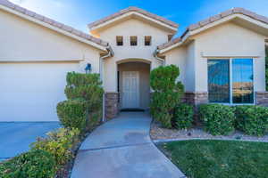 View of exterior entry featuring a garage