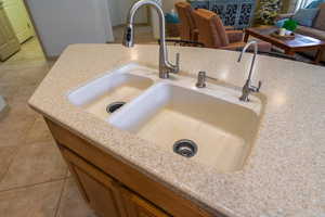 Room details featuring composite granite sink, R?O water system and faucet with bushed nickel finish