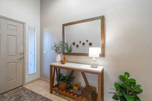 Entrance foyer with a healthy amount of sunlight and light tile patterned flooring