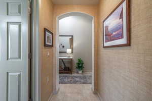 Hall from 2nd bedroom to entry featuring light tile patterned floors