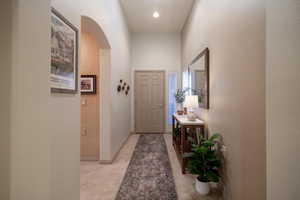 Entry hallway with light tile patterned flooring. Entrance to hall to 2nd bed & bath on left