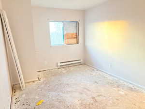 Empty room with a baseboard heating unit