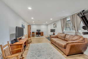 Living room with light hardwood / wood-style floors