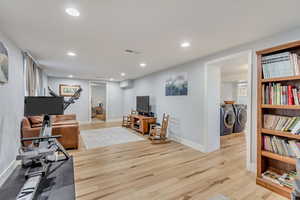 Office featuring washer and dryer and light wood-type flooring