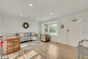 Living room with light hardwood / wood-style floors