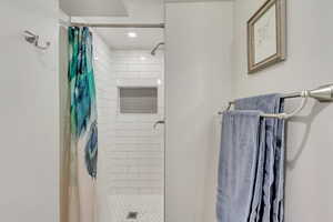 Bathroom featuring curtained shower