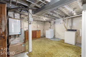 Basement featuring washing machine and clothes dryer and water heater