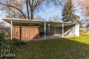 View of outdoor structure with a lawn