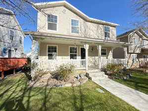 View of front of home with a front lawn and covered porch