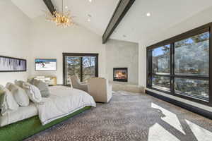 Bedroom with carpet, high vaulted ceiling, a fireplace, a notable chandelier, and beam ceiling