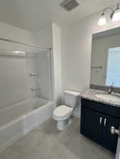 Full bathroom with tile patterned flooring, vanity, bathing tub / shower combination, and toilet