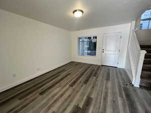 Entryway featuring dark hardwood / wood-style flooring and a textured ceiling