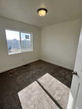 Unfurnished room with carpet flooring