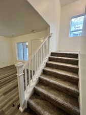 Stairs featuring wood-type flooring