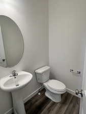 Bathroom featuring toilet and wood-type flooring