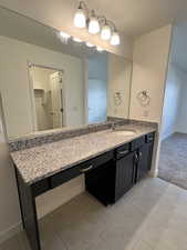 Bathroom featuring tile patterned flooring and vanity