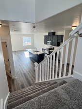 Staircase featuring wood-type flooring and sink