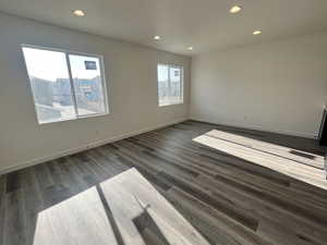 Empty room with dark hardwood / wood-style floors